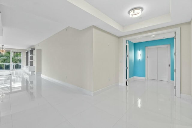 2720 Donald Ross Rd Unit 301, Palm Beach Gardens, FL 33410 - spare room with elevator, baseboards, and light tile patterned flooring