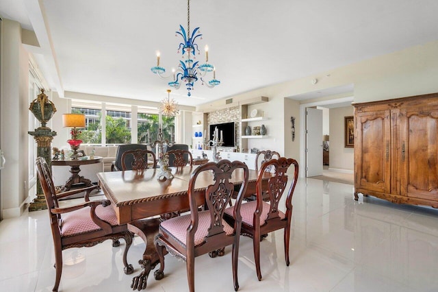 dining area featuring a chandelier and light tile floors