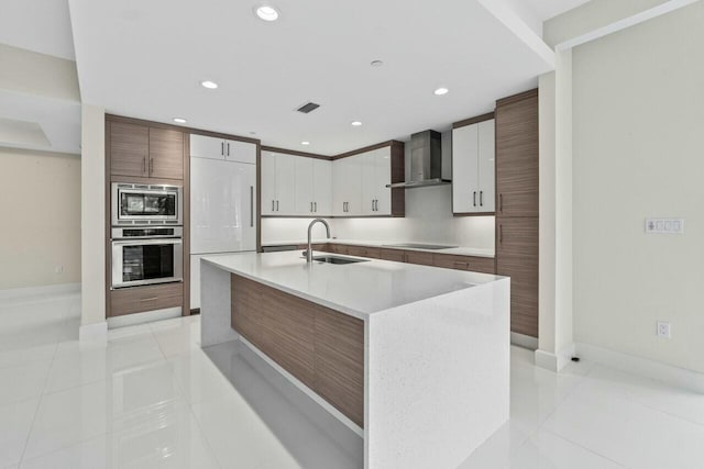 2720 Donald Ross Rd Unit 301, Palm Beach Gardens, FL 33410 - kitchen with a sink, appliances with stainless steel finishes, light tile patterned floors, and wall chimney exhaust hood