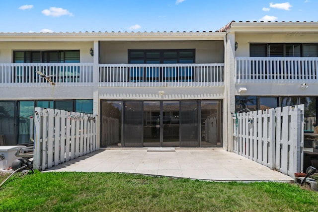 rear view of property featuring a balcony