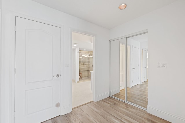 unfurnished bedroom with a closet and light wood-type flooring