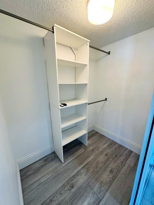 bathroom featuring walk in shower, double sink, tile flooring, and vanity with extensive cabinet space