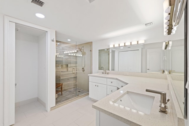 bathroom featuring walk in shower and vanity