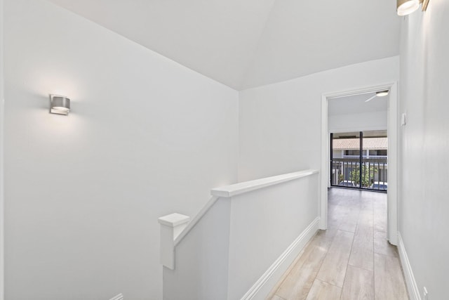 empty room featuring light hardwood / wood-style flooring, high vaulted ceiling, and ceiling fan