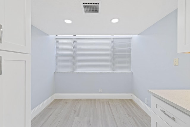 unfurnished dining area with light hardwood / wood-style flooring