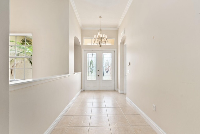 foyer featuring french doors, crown molding, baseboards, and light tile patterned floors