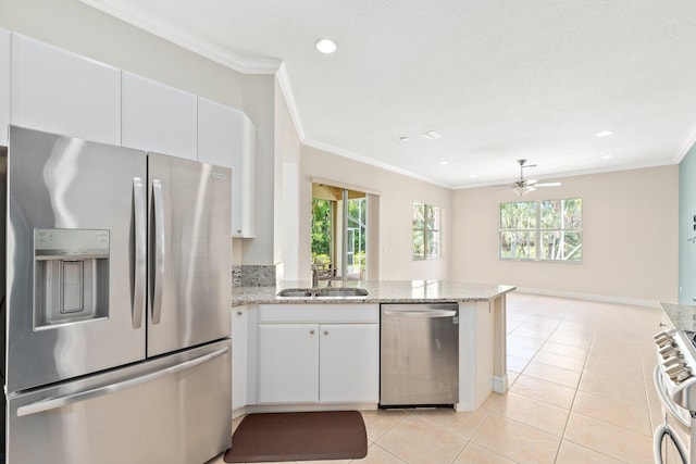 kitchen featuring white cabinetry, ornamental molding, stainless steel appliances, and a sink