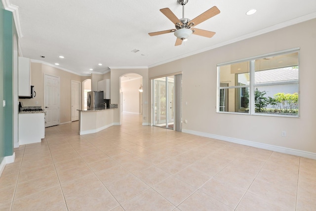 unfurnished living room with light tile patterned floors, baseboards, arched walkways, and ornamental molding