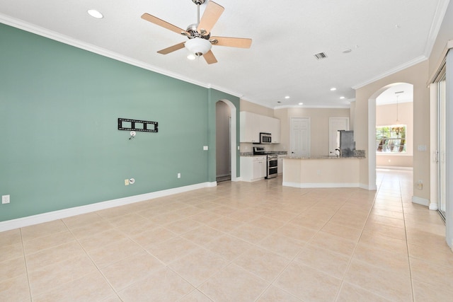 unfurnished living room featuring baseboards, arched walkways, a ceiling fan, ornamental molding, and light tile patterned flooring