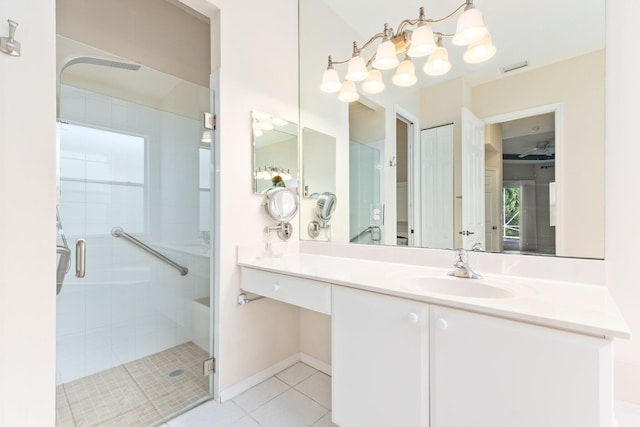 full bath featuring visible vents, baseboards, vanity, a shower stall, and tile patterned floors