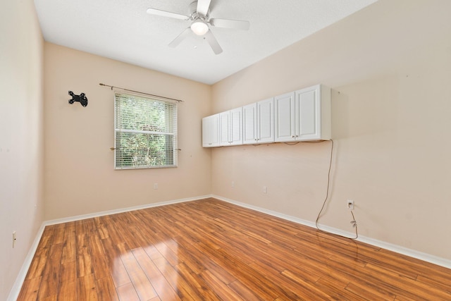 unfurnished room with light wood-style floors, ceiling fan, and baseboards