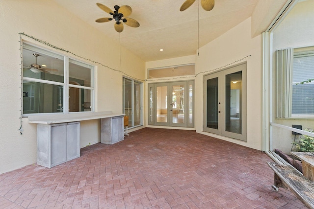 unfurnished sunroom with french doors and ceiling fan