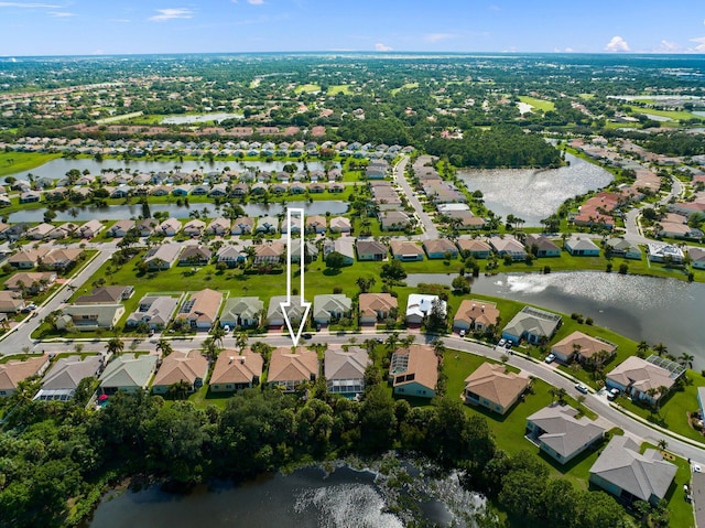 drone / aerial view with a water view and a residential view