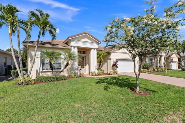 view of front of property with an attached garage, a tile roof, decorative driveway, stucco siding, and a front lawn