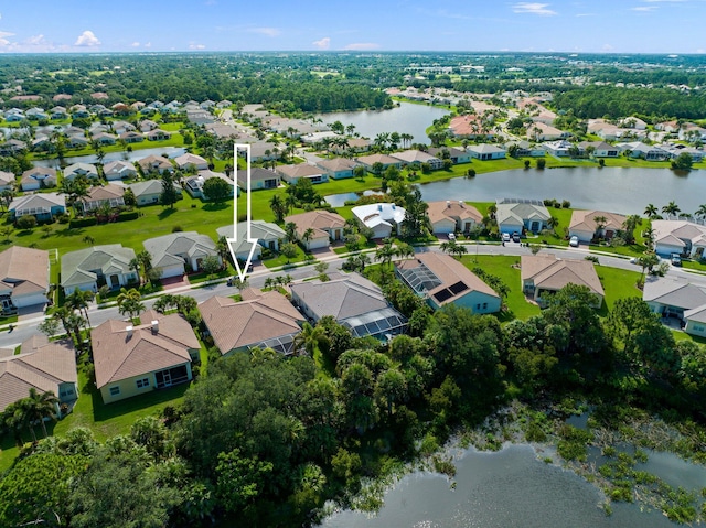 birds eye view of property with a residential view and a water view