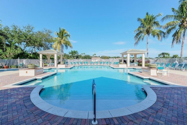 pool featuring a gazebo, a patio area, and fence