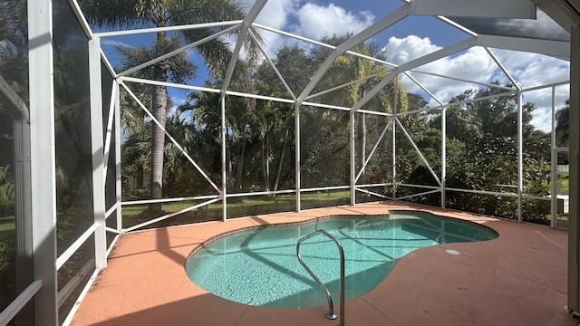 pool featuring a lanai and a patio area