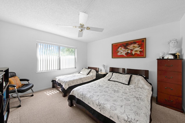 bedroom featuring ceiling fan, light carpet, and a textured ceiling