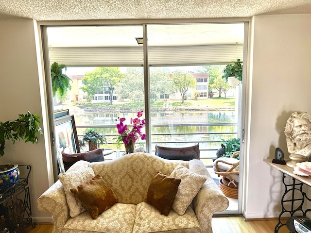 sunroom / solarium with plenty of natural light and a water view