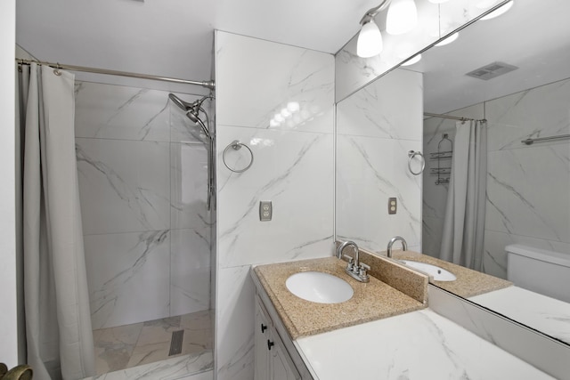 bathroom featuring a shower with shower curtain, vanity, tile walls, and visible vents