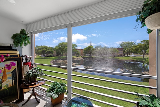 sunroom / solarium with a water view