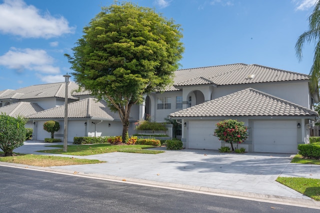 mediterranean / spanish-style home with a garage