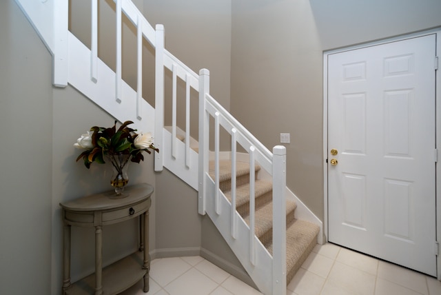 stairway with light tile floors