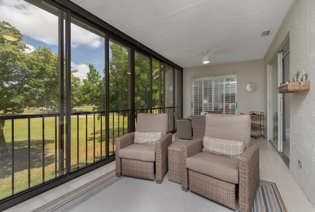 sunroom / solarium with a healthy amount of sunlight and ceiling fan