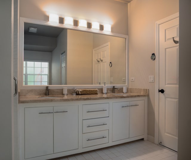 bathroom with tile floors and dual vanity