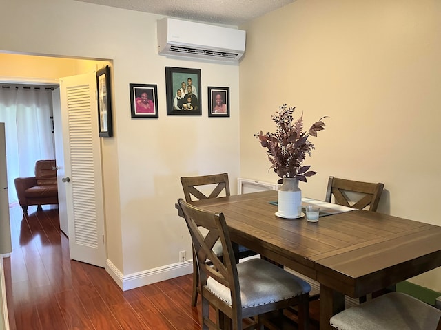 dining area with a wall unit AC and dark wood-type flooring