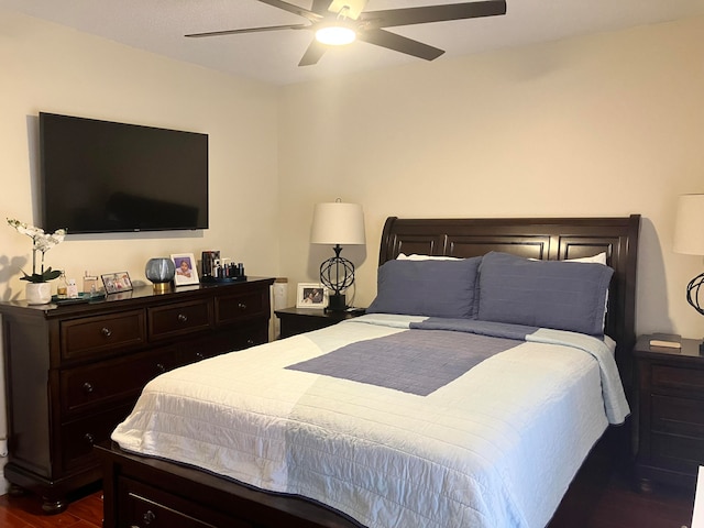 bedroom with ceiling fan and dark wood-type flooring