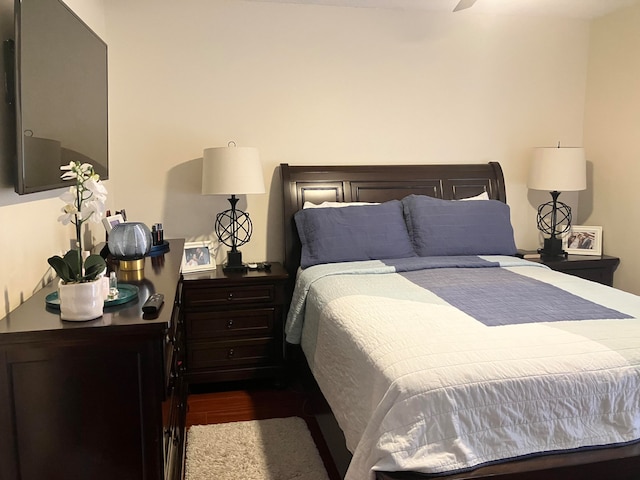 bedroom featuring dark hardwood / wood-style flooring and ceiling fan