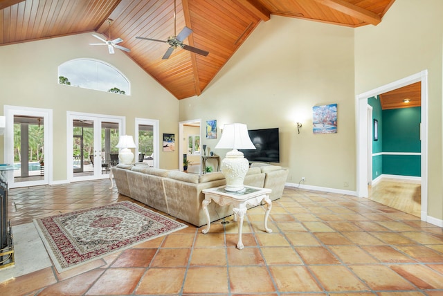 tiled living room with high vaulted ceiling, beamed ceiling, french doors, wood ceiling, and ceiling fan