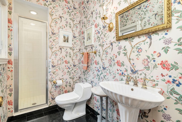 bathroom featuring a shower with shower door, toilet, and tile floors