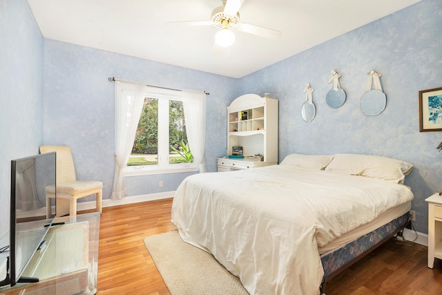 bedroom featuring ceiling fan and hardwood / wood-style floors