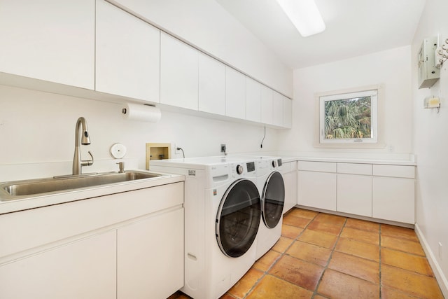 clothes washing area featuring hookup for a washing machine, cabinets, washer and clothes dryer, sink, and light tile floors