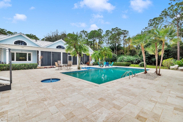 view of swimming pool with a patio area