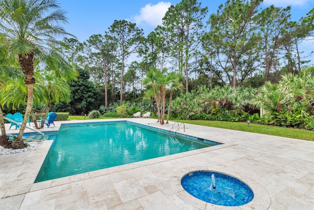 view of pool featuring a patio area and a hot tub