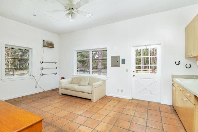 unfurnished room featuring sink, a wall mounted air conditioner, ceiling fan, and light tile floors