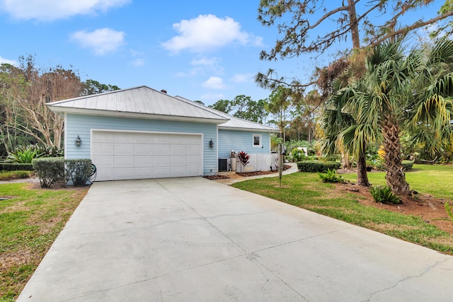 view of front of home with a front lawn and central AC