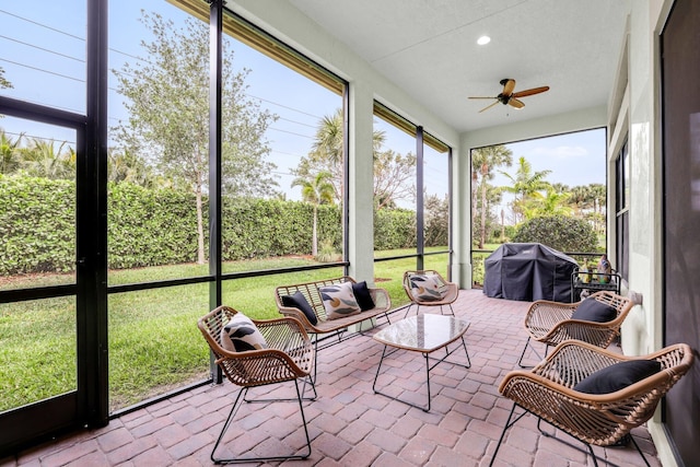 sunroom featuring ceiling fan