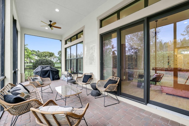 sunroom / solarium featuring ceiling fan and a healthy amount of sunlight