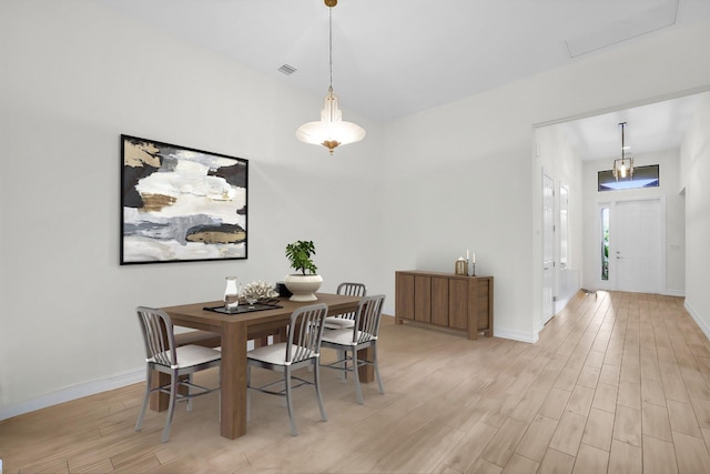 dining space with light hardwood / wood-style floors