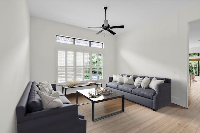 living room with a healthy amount of sunlight, light hardwood / wood-style floors, and ceiling fan