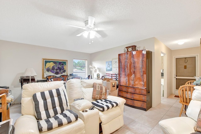 tiled living room featuring a textured ceiling and ceiling fan