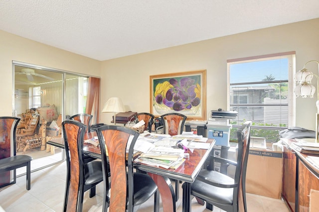 tiled dining space featuring a textured ceiling