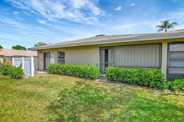 view of side of home with a lawn