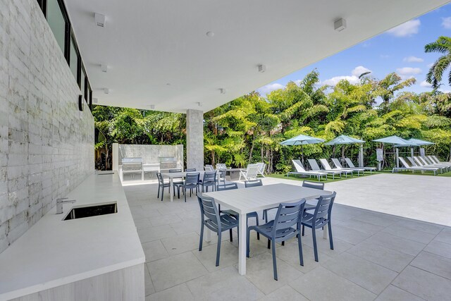 view of patio featuring sink and a community pool