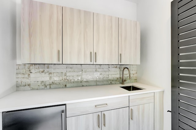 kitchen with sink, light brown cabinets, wine cooler, and backsplash