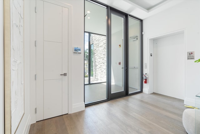 interior space featuring light hardwood / wood-style flooring, a wealth of natural light, and expansive windows